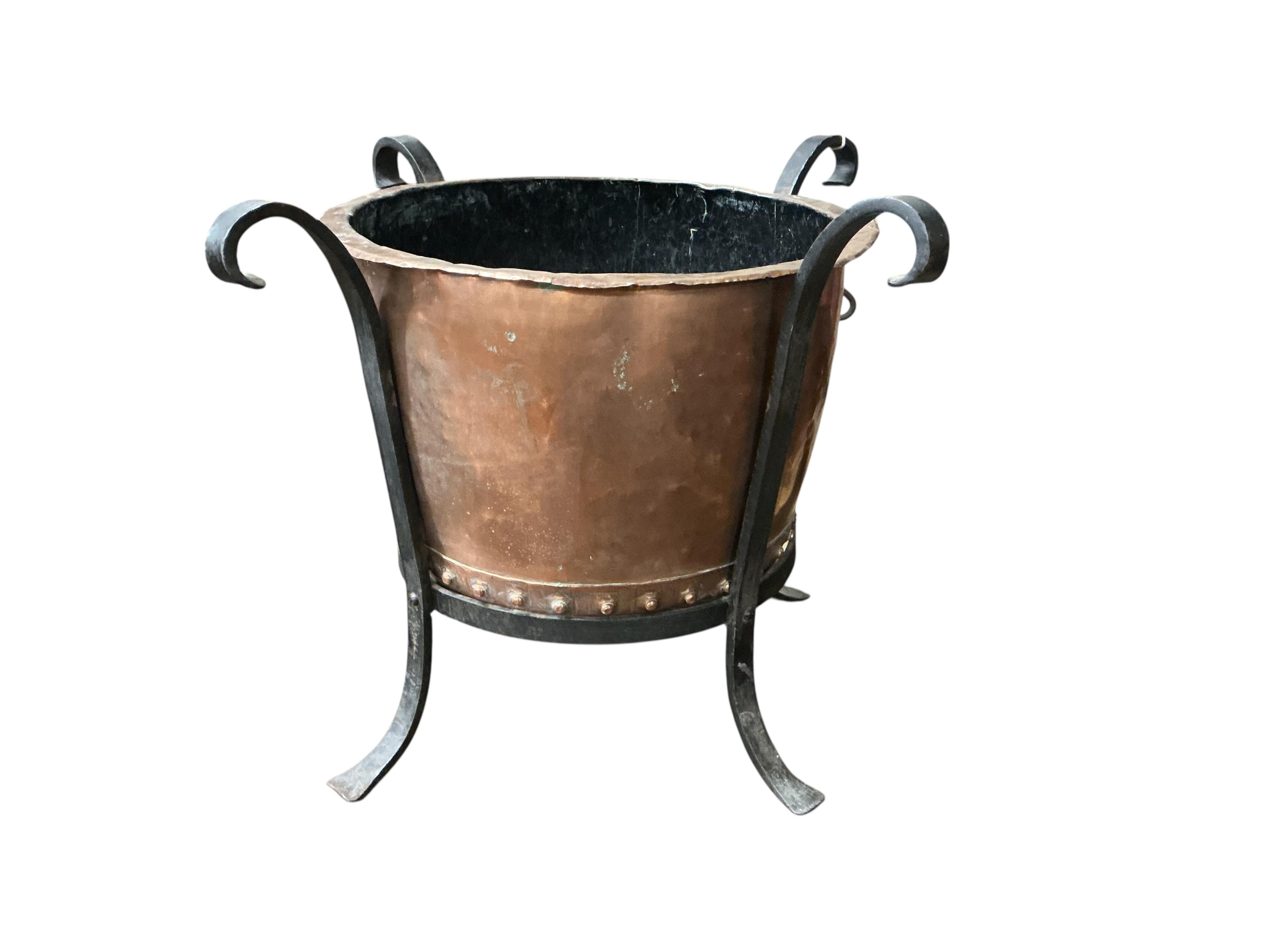 A small Victorian circular copper copper, raised in a wrought iron frame, width 64cm, height 50cm